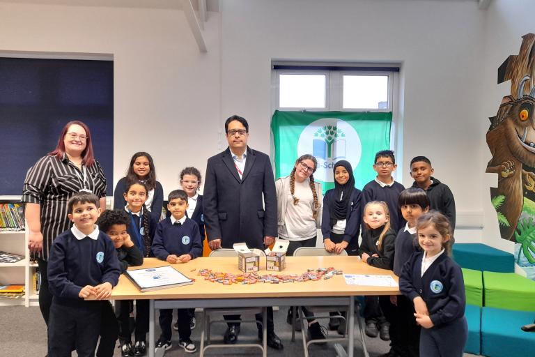 Councillor Haroon with Henry Green Primary School children showing some of the batteries they have collected for recycling