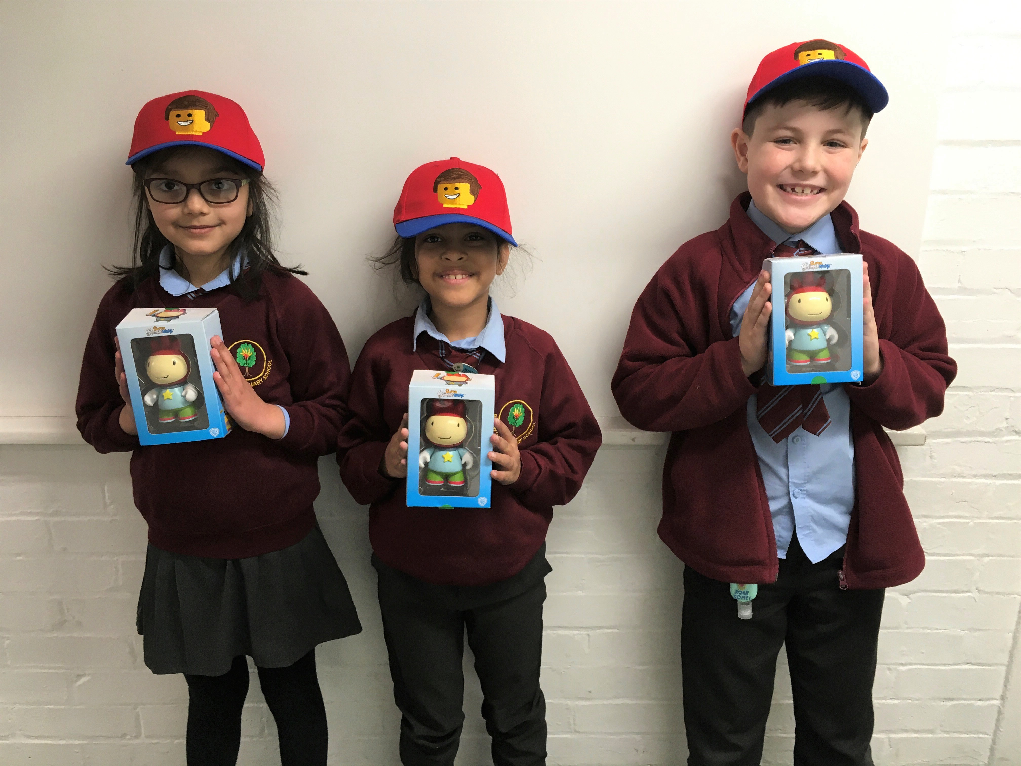 children holding up film merchandise