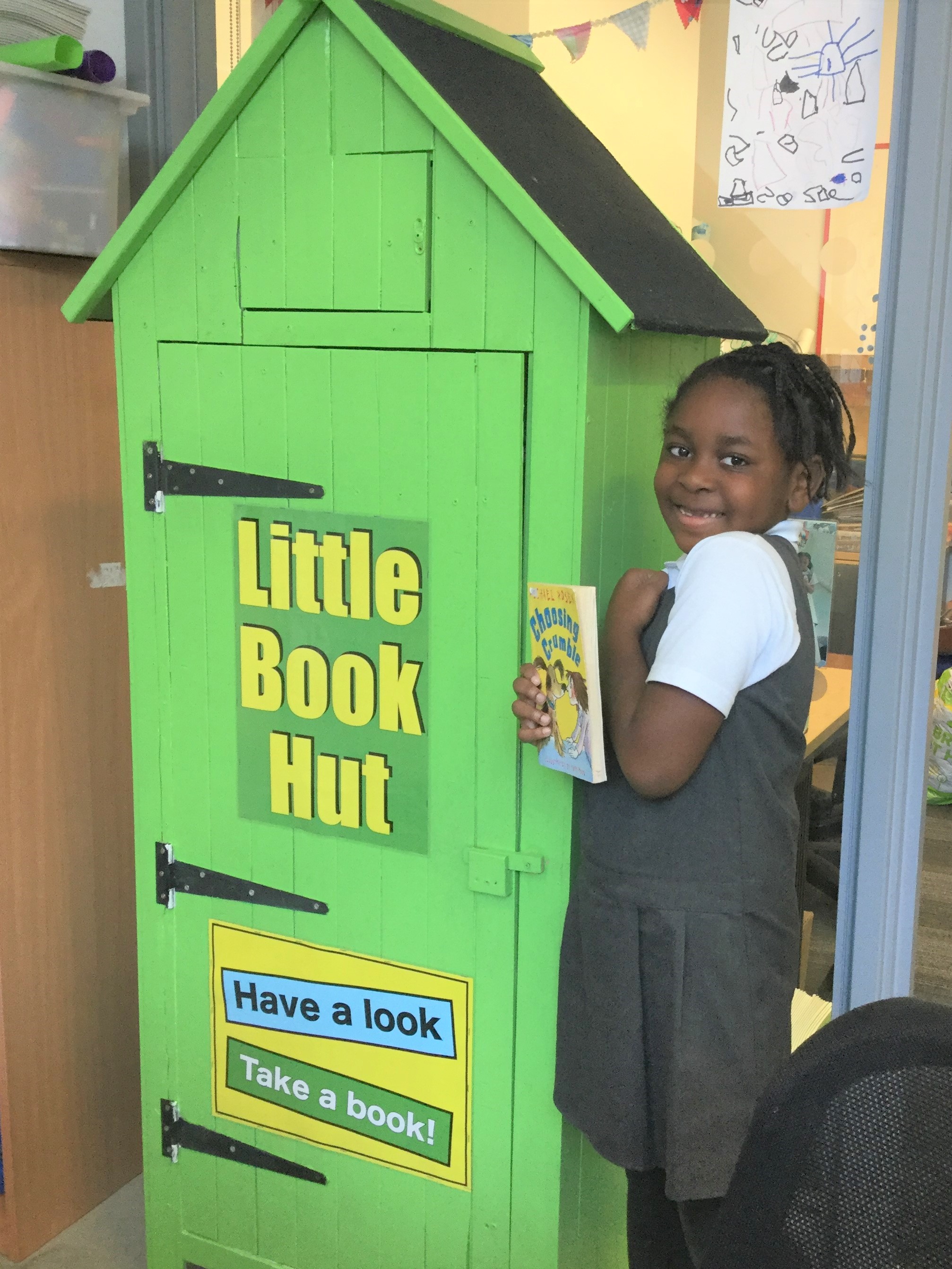girl with book next to pop up reading hut