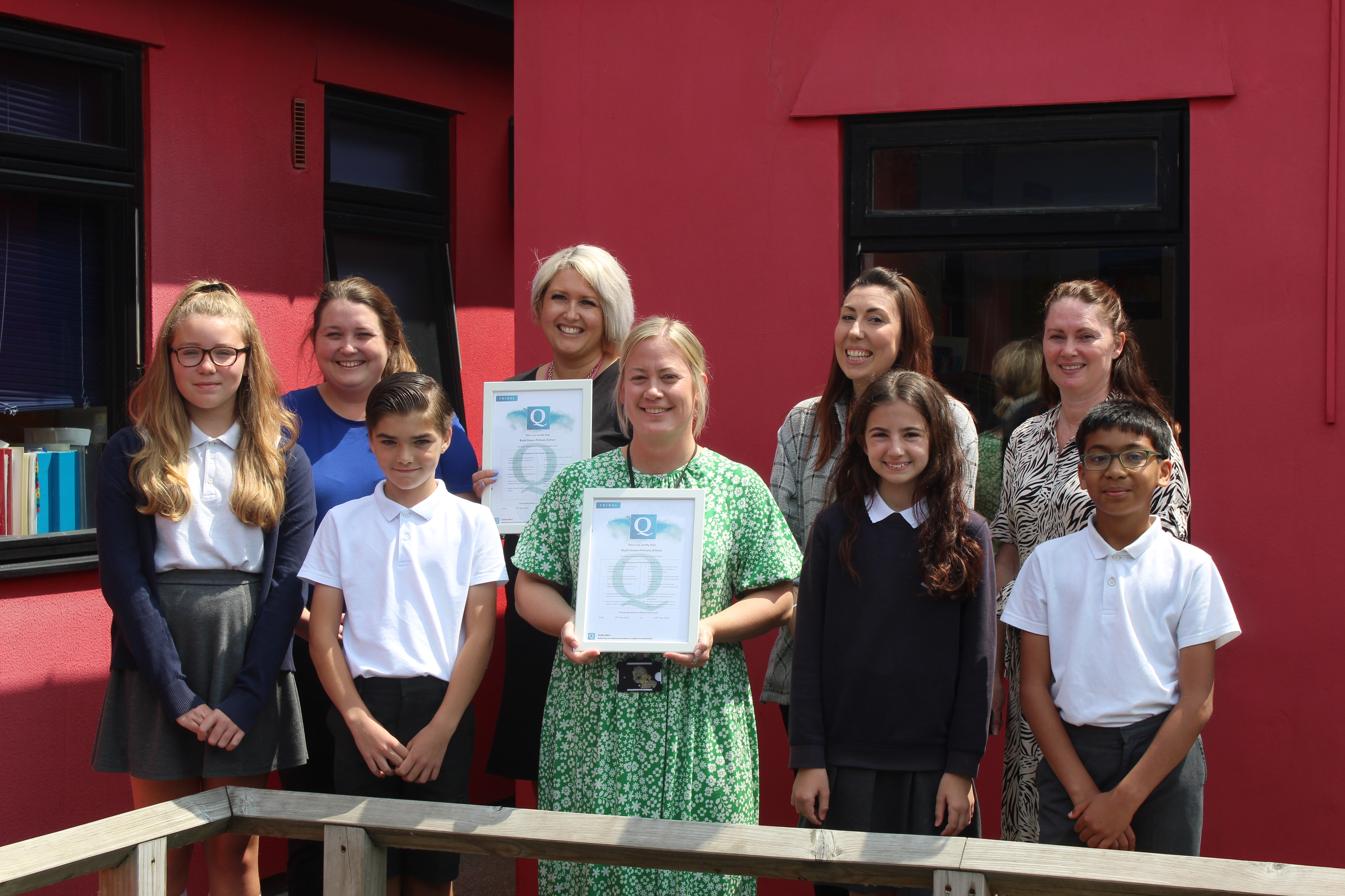 Staff and pupils from Rush Green Primary School with awards