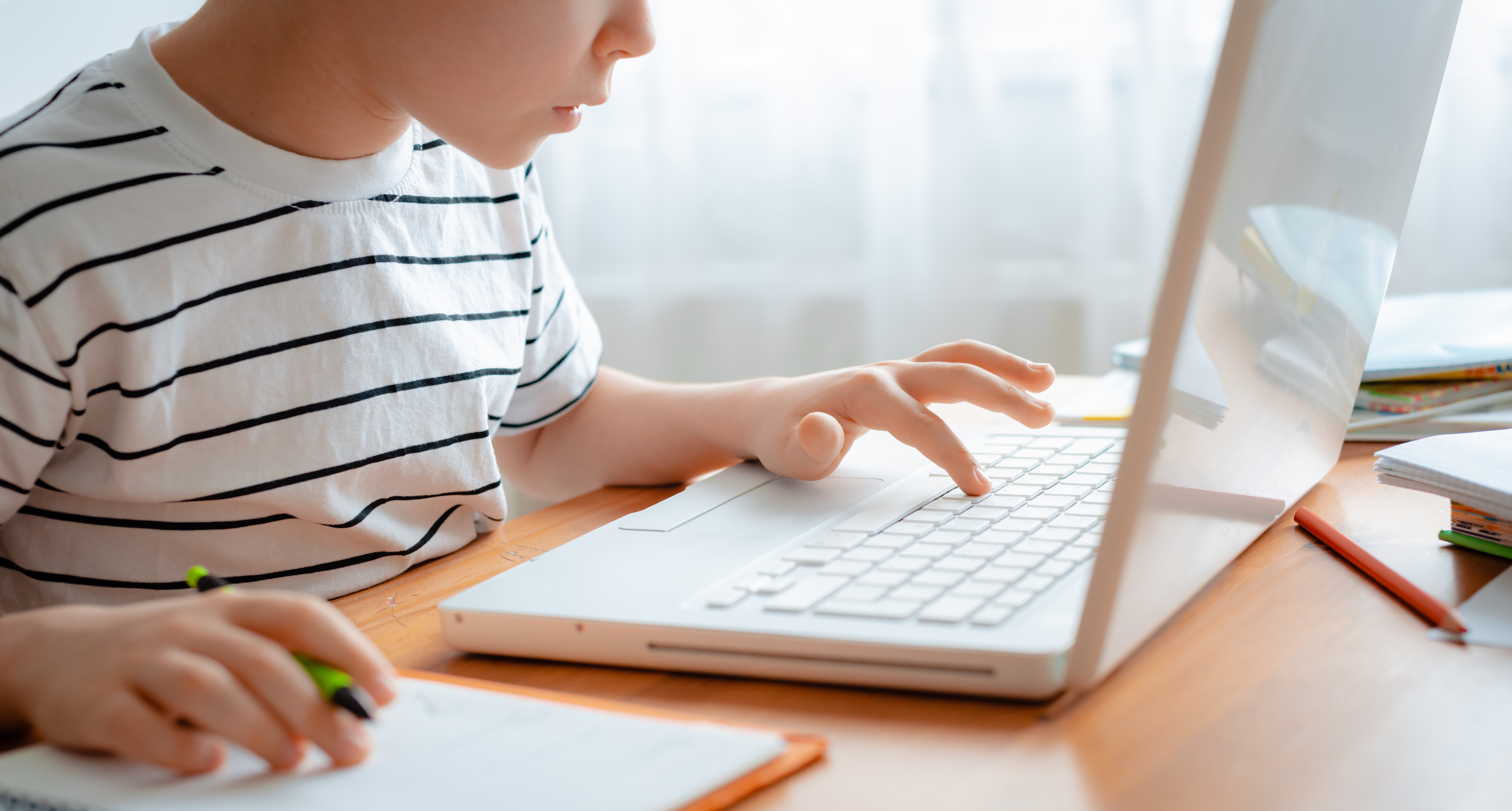 child learning on laptop at home
