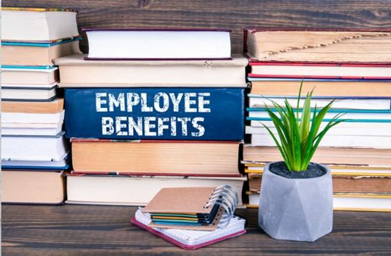 Stack of books, one saying Employee benefits on it