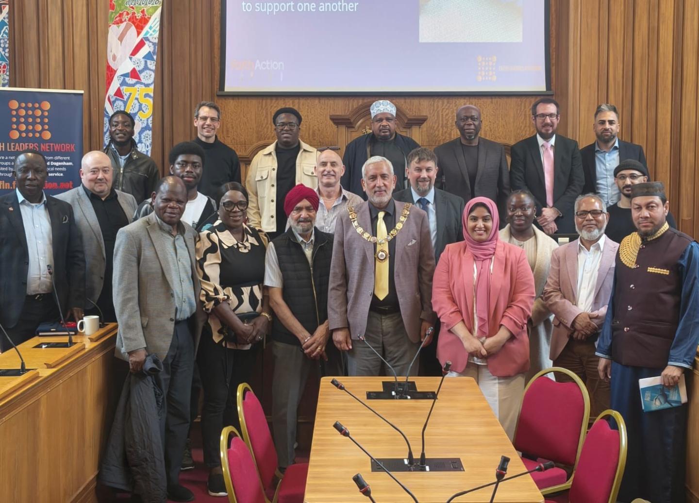 Barking & Dagenham Faith Leaders Network members standing in the Council Chamber in the Town Hall