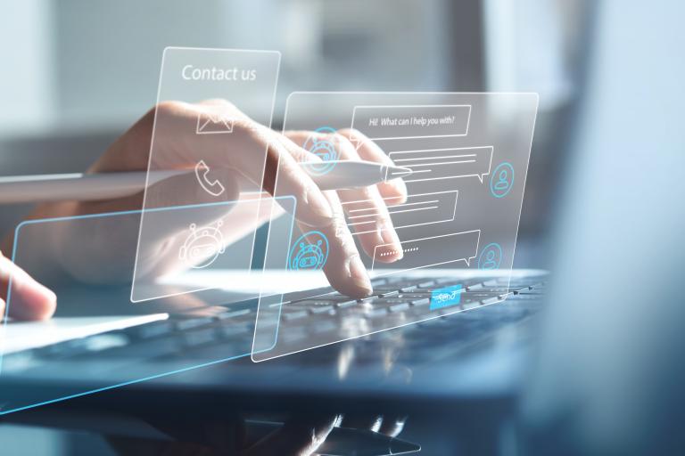 Photo of hands on a laptop keyboard