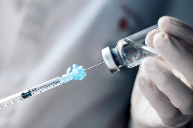 Photo of a needle going into an arm for a vaccine