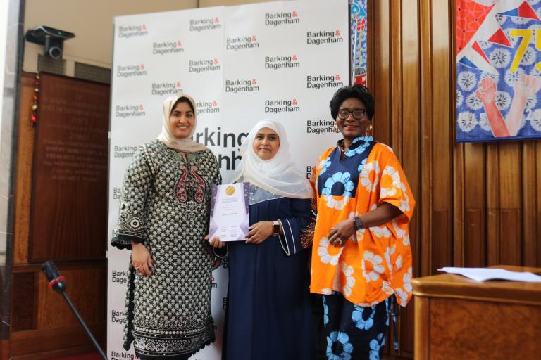 Ansarun Ahmed is showing their winning certificate in the Town Hall with Cllr Ashraf and Cllr Bright