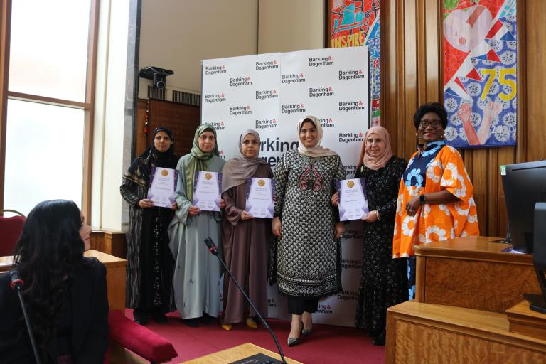 Members of the  Al Madina Female Funeral Team are showing their winning certificate in the Town Hall