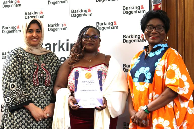 Winnet Wadzanai Nyirenda is showing their winning certificate in the Town Hall with Cllr Ashraf and Cllr Bright