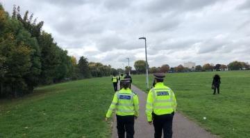 Police and enforcement officers patrolling through park