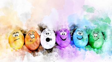 Colourful eggs with different facial expressions surrounded by colourful brush strokes