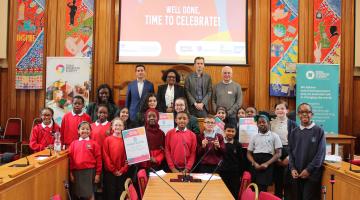 Panel of dragons, pupils, and teachers celebrate at the end of the event 