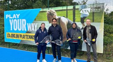 Councillors and officers holding rackets on tennis court 