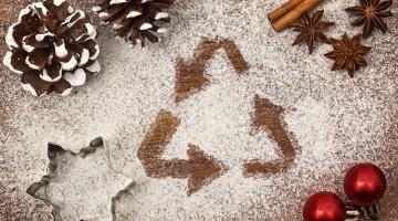 Recycling sign on a Christmas-laden table