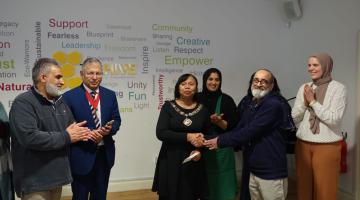 Mayor receiving a cheque for charity
