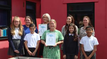 Staff and pupils from Rush Green Primary School with awards