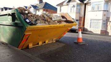 Skip full of rubbish on the road