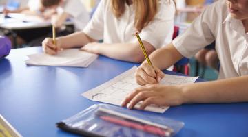 children writing in classroom