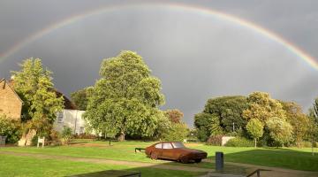 Valence House with a rainbow in the background