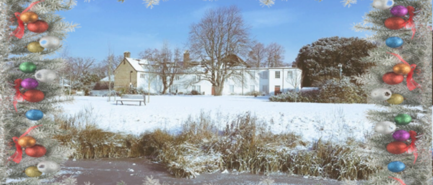 A Christmas card with a snowy landscape scene