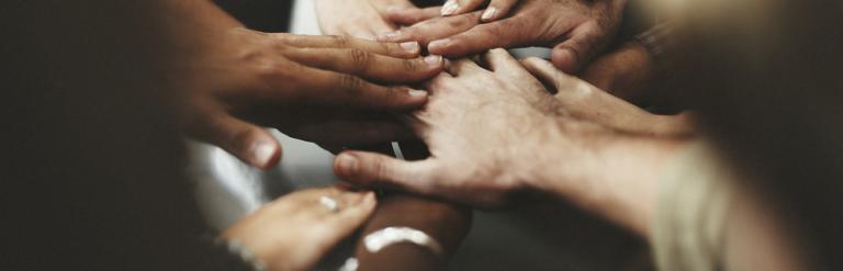 hands joining in the middle to volunteer