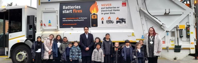 Councillor Haroon with Henry Green Primary School pupils standing in front of a bin truck