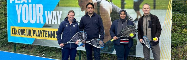 Councillors and officers holding rackets on tennis court 