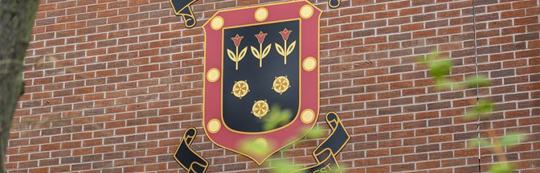 Barking Abbey School's logo on school building