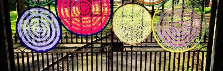 Knitted circles on a gate