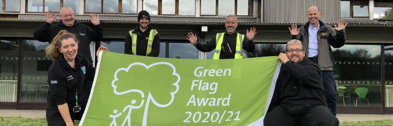 People holding a green flag