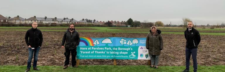 Forest of thanks sign with 4 people