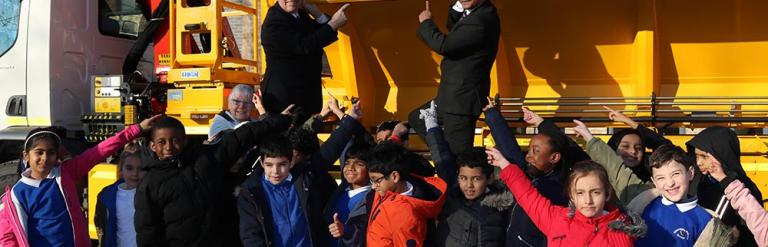 Image of school children and councillors in front of the newly named gritter