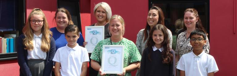 Staff and pupils from Rush Green Primary School with awards