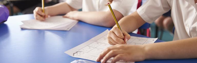 children writing in classroom