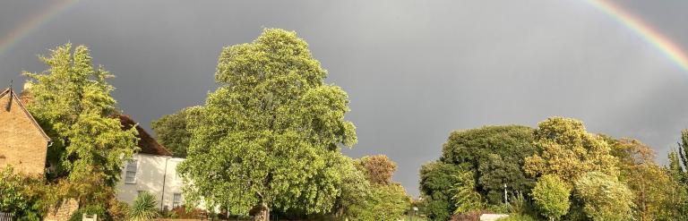 Valence House with a rainbow in the background