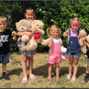 photo of children holding teddy bears. 